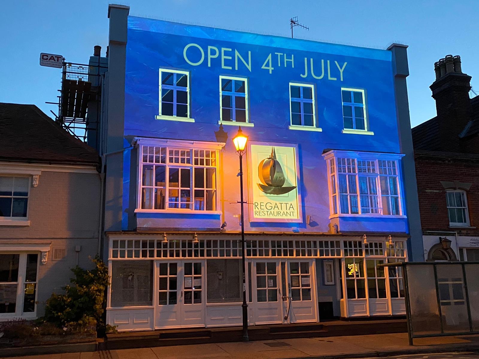 regatta restaurant front with opening date projection